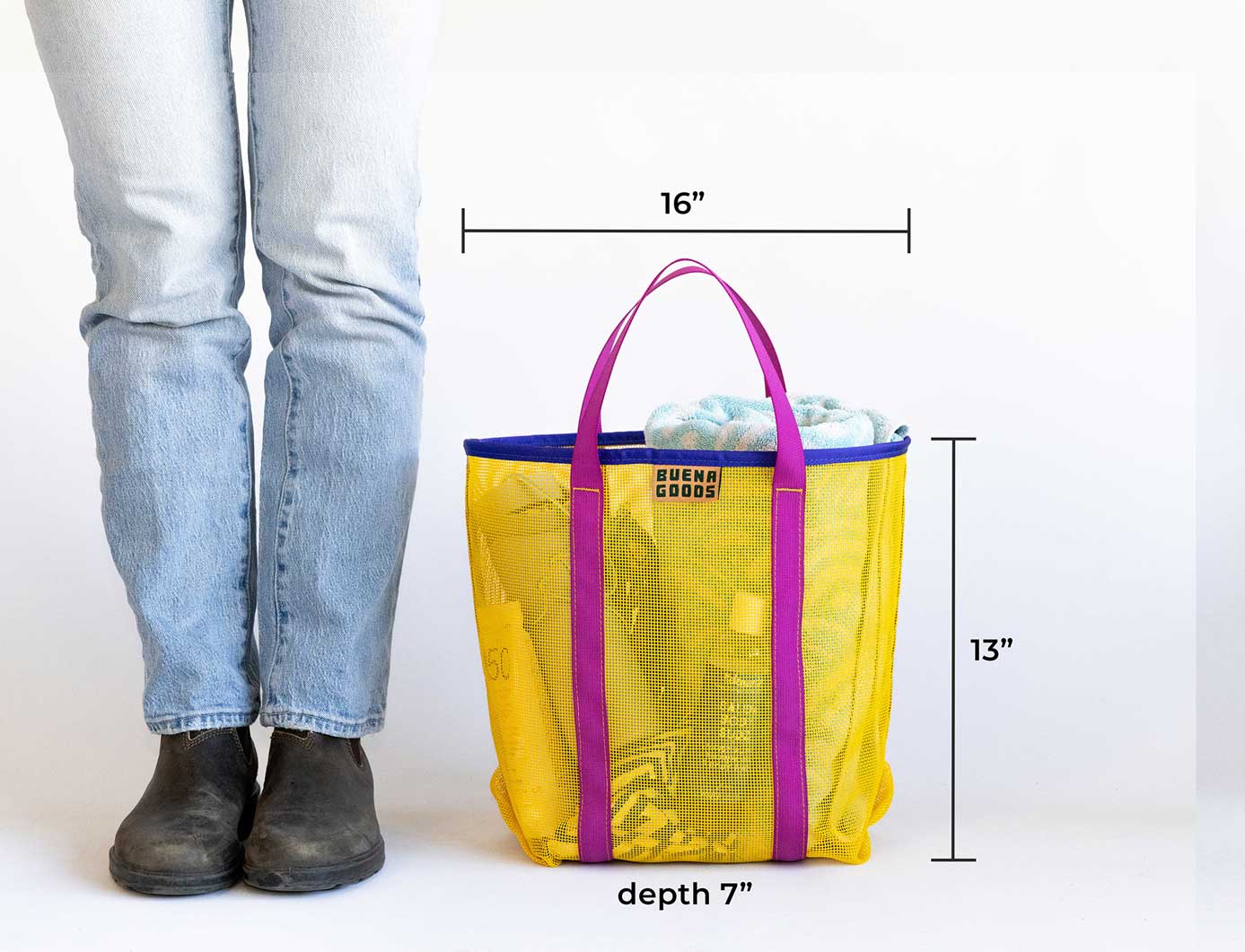 Yellow tote bag with purple handles held by a person, showing dimensions on a white background